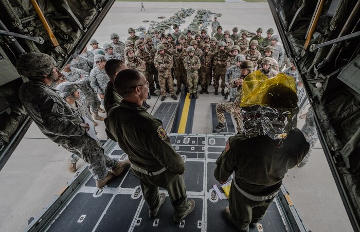 U.S. Air Force National Guard Airman 1st Class Hunter Goodan, 165th Airlift Squadron loadmaster, demonstrates how an oxygen masks works in case of an inflight emergency for U.S. Army, Royal Canadian Regiment and Italian Esercito soldiers on Ramstein Air Base, Germany, Sept. 3, 2014. The U.S. Air Force and Air National Guard support Steadfast Javelin II by providing personnel air drop and air landings in support of forcible entry and force projection,  reinforcing the joint commitment to Operation Atlantic Resolve, and a  demonstrated commitment to our NATO allies and security in Eastern Europe. (U.S. Air Force photo/Airman 1st Class Jordan Castelan)