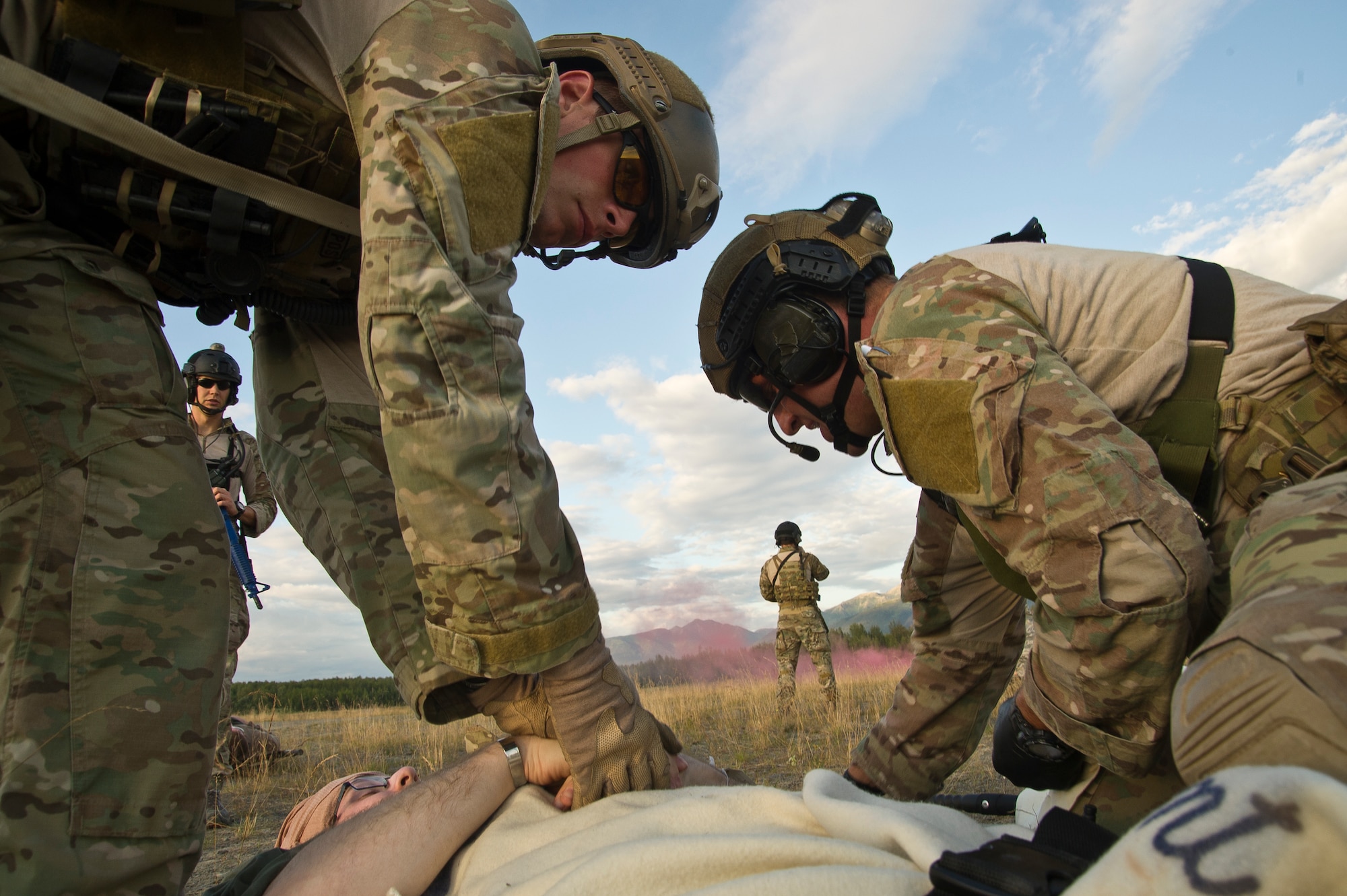 U.S. Air Force pararescuemen also known as PJ (para-jumper) from the, Alaska Air National Guard Joint Base Elmendorf-Richardson, Alaska, and (Pararescue/Guardian Angels) from Davis-Monthan AFB Ariz., provide medical treatment to a simulated wounded service member during simulated mass casualty combat training scenario July 30, 2014. The PJs are responsible for providing emergency and lifesaving services to military personnel and civilians in both peacetime and combat environments, they go behind enemy lines before anyone else to set on a drop zone/air field and help call in fire support.
