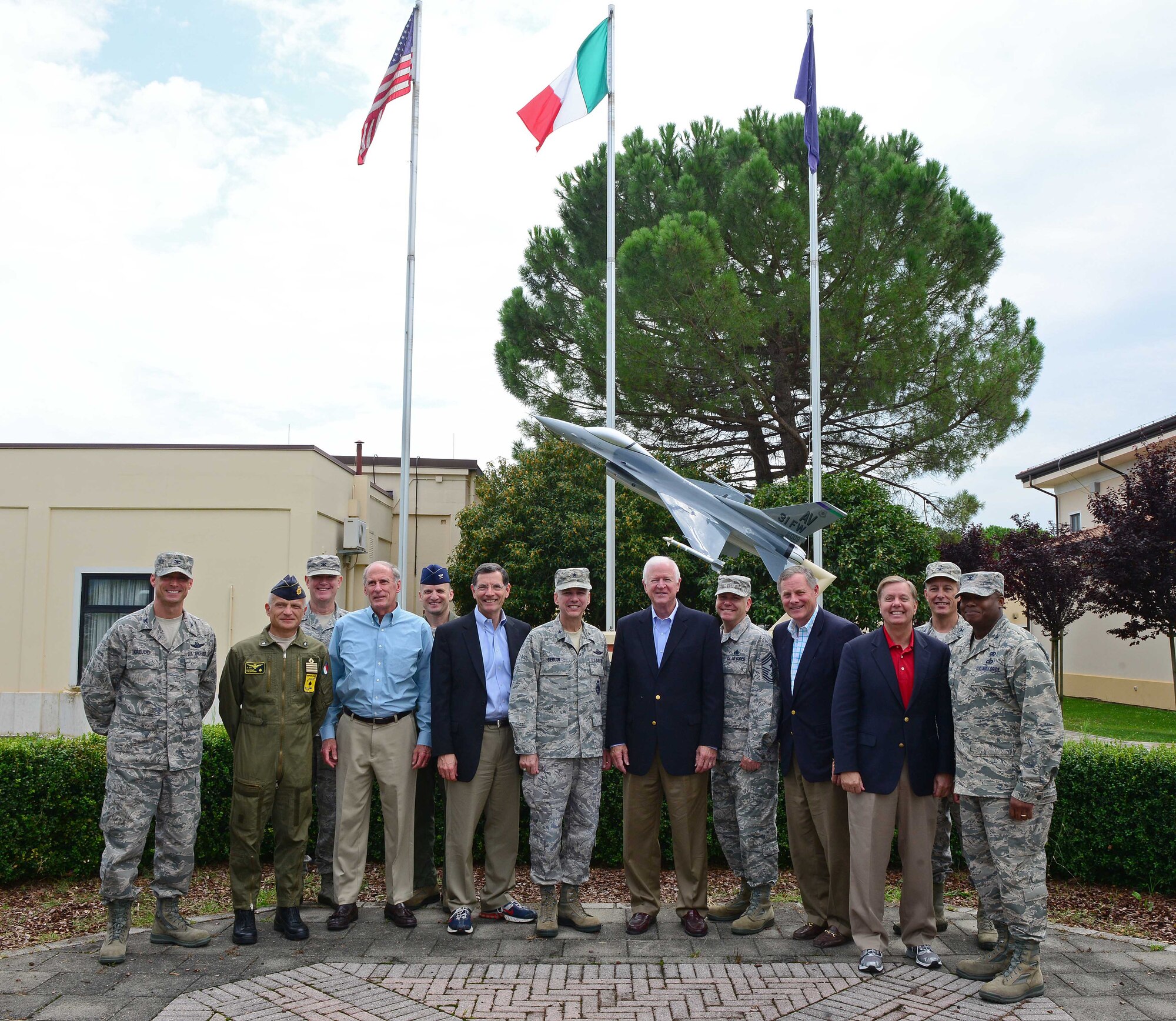 Leadership from the 31st Fighter Wing stands with U.S. senators, Sept. 4, 2014, at Aviano Air Base, Italy. The visit gave the guests a chance to meet with wing leadership, talk with Airmen and receive important mission briefs and a tour of the base. (U.S. Air Force photo/Senior Airman Matthew Lotz)