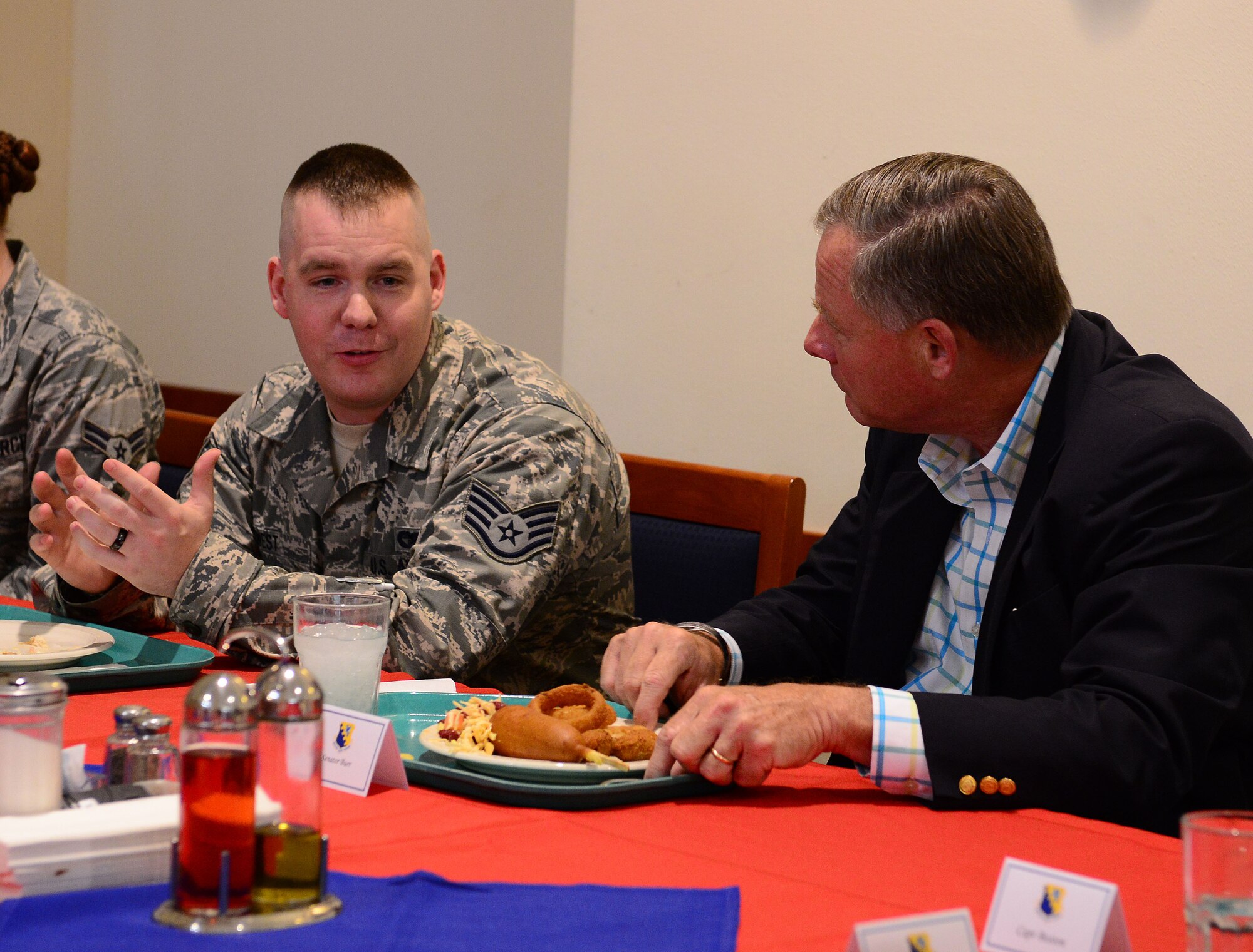 Staff Sgt. Timothy West, 724th Air Mobility Squadron, speaks with North Carolina Senator Richard Burr, Sept. 4, 2014, at Aviano Air Base, Italy. During a luncheon, Airmen got to speak to their home state senators about where they are from and life overseas in the military. (U.S. Air Force photo/Senior Airman Matthew Lotz)