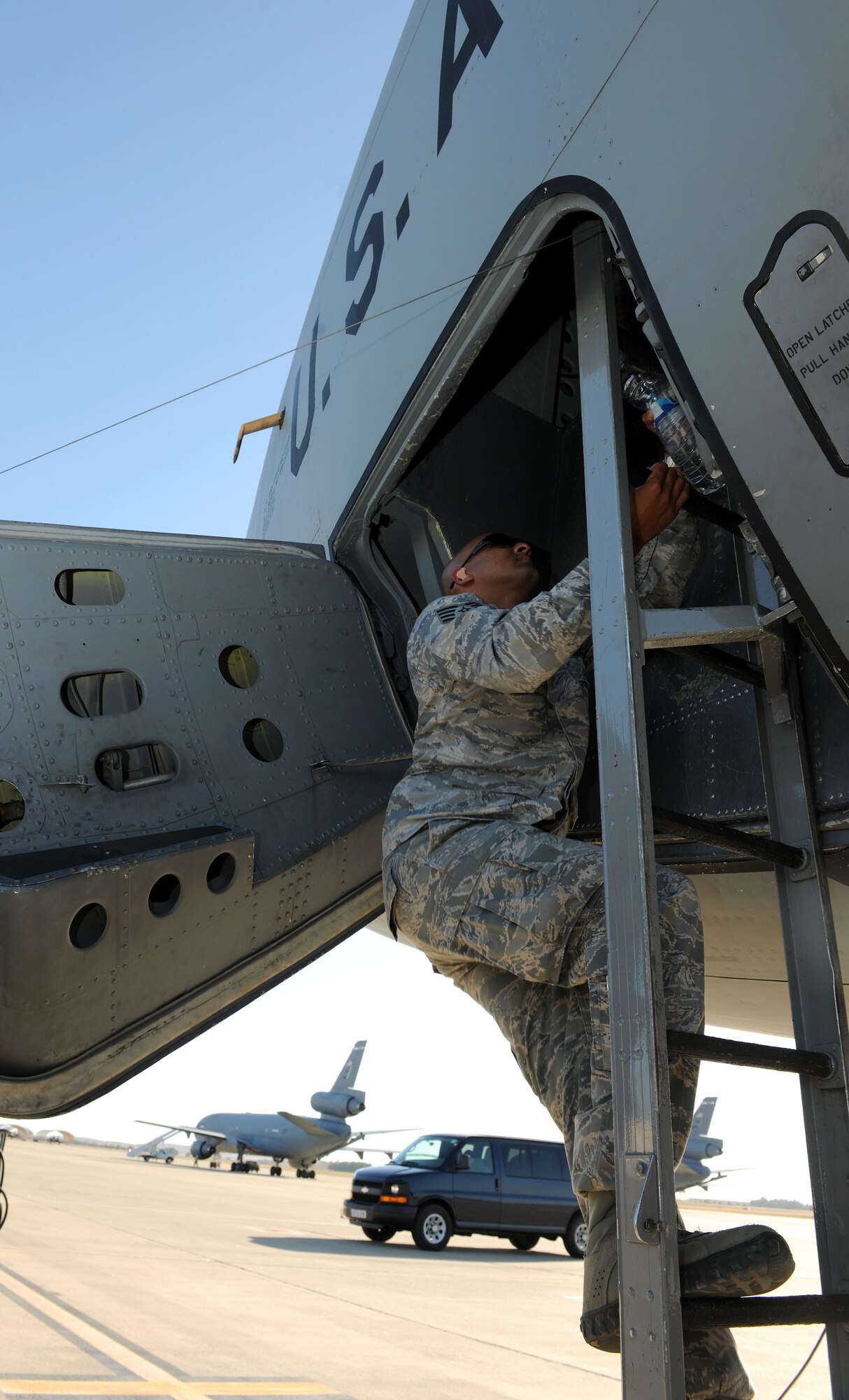 U.S. Air Force Staff Sgt. Duane Gopie, 100th Maintenance Group Quality Assurance inspector from New York City, climbs into a KC-135 Stratotanker Aug. 27, 2014, for a return flight to RAF Mildenhall after a three-month deployment to Moron Air Base, Spain. Aircrew and mainteance Airmen assigned to the 100th ARW perform tail swaps reguarly, which refers to when tail numbers on aircraft paperwork are literally swapped and those Airmen who are deployed to Moron AB return home, helping promote higher morale and mission effectiveness. (U.S. Air Force photo/Senior Airman Kate Maurer/Released)