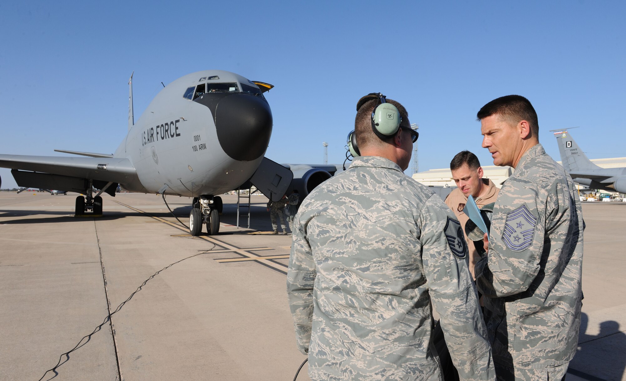 U.S. Air Force Chief Master Sgt. Tracy Jones, right, 100th Air Refueling Wing command chief, speaks with U.S. Air Force Master Sgt.  Richard Watts, 100th Aircraft Maintenance Squadron production superintendent from Woodville, Ala., Aug. 27, 2014, during a visit to Moron Air Base, Spain. Leadership from the 100th ARW visited their Airmen at Moron AB to not only see first-hand their impact on the mission but to ensure morale was at its highest. (U.S. Air Force photo/Senior Airman Kate Maurer/Released)