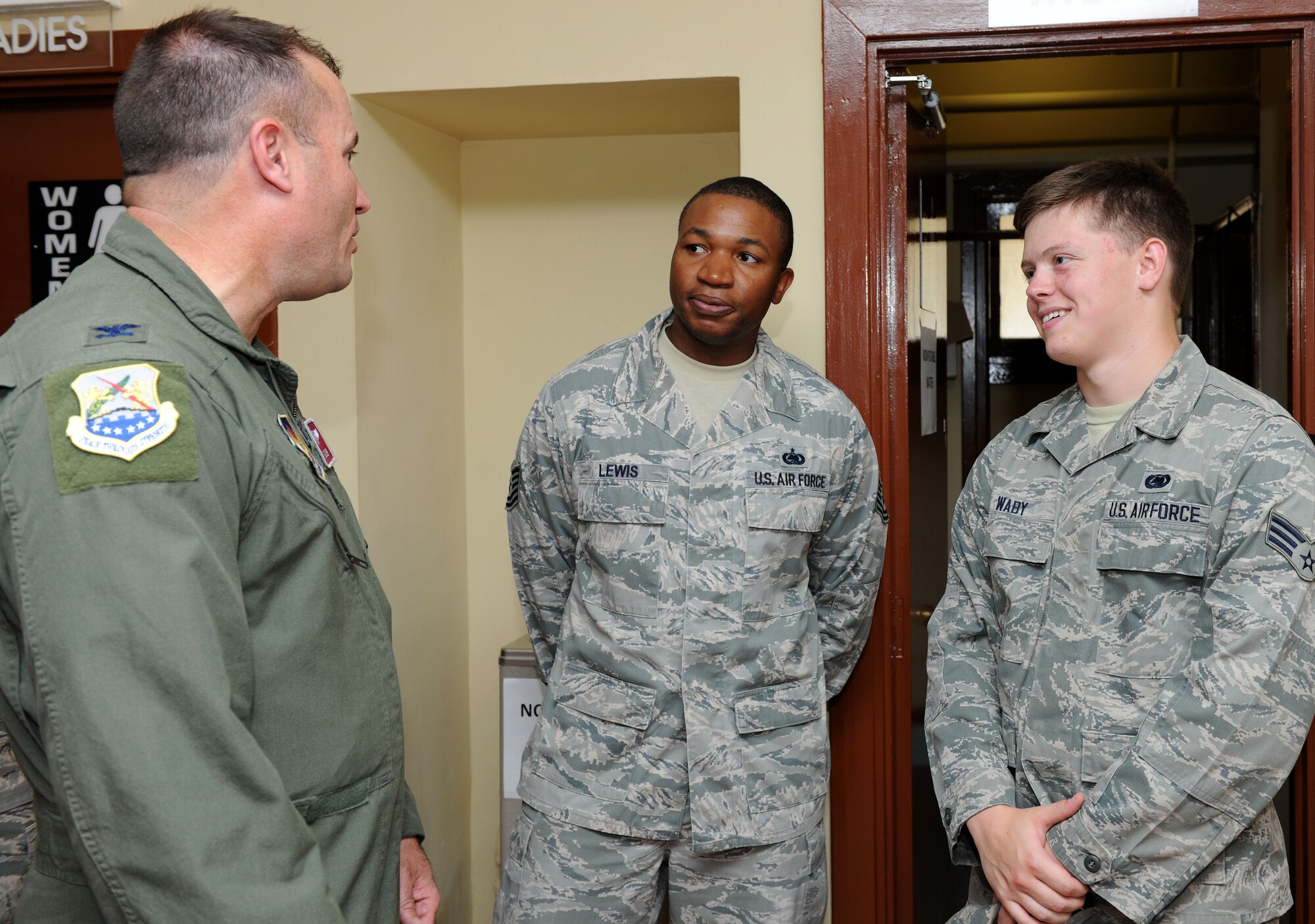 U.S. Air Force Col. Kenneth T. Bibb, Jr., left, 100th Air Refueling Wing commander, speaks with U.S. Air Force Tech. Sgt. Carlos Lewis, center, 100th Logistics Readiness Squadron NCO in charge of the Mission Readiness Spares Package section from Oakland, Calif., and U.S. Air Force Senior Airman Cameron Waby, 100th LRS MRSP technician from Brandon, Minn., Aug. 27, 2014, during a visit to Moron Air Base, Spain. Leadership from the 100th ARW visited their Airmen at Moron AB to not only see first-hand their impact on the mission but to ensure morale was at its highest. (U.S. Air Force photo/Senior Airman Kate Maurer/Released)
