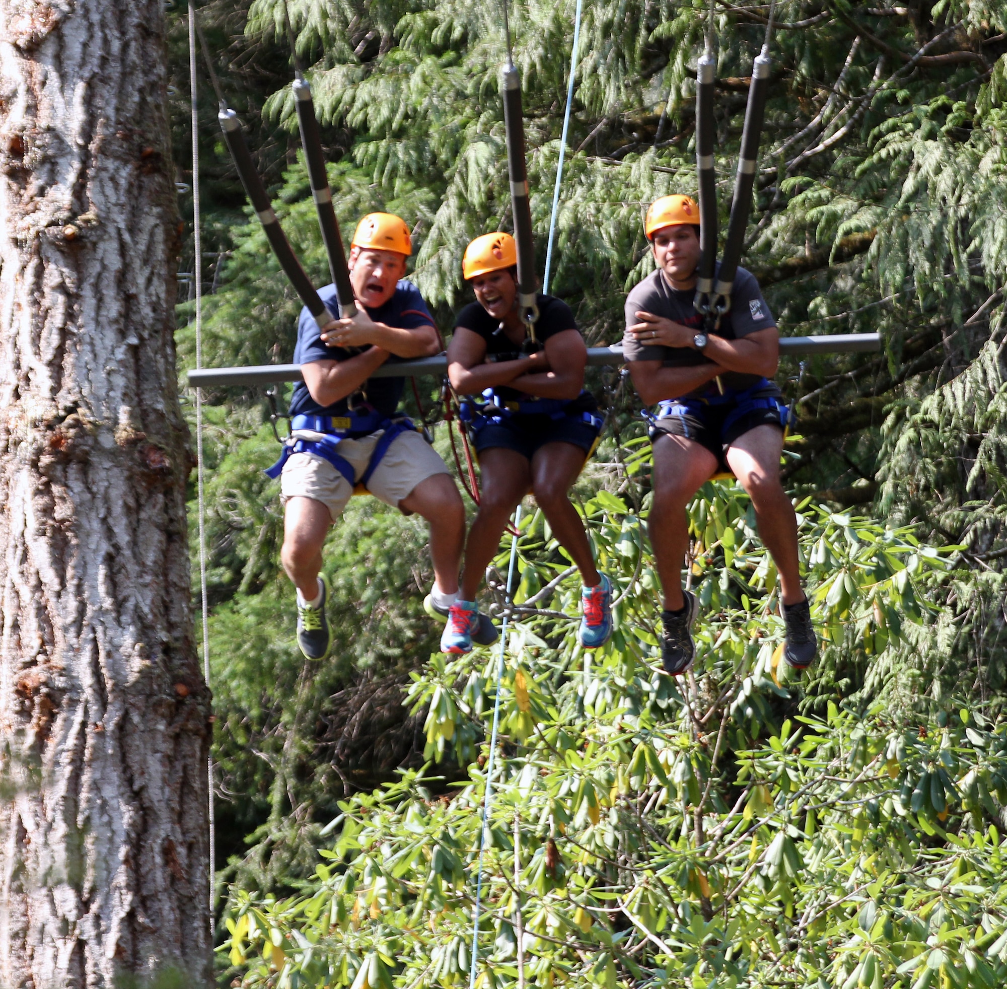 From left to right, Maj. Robert Wilkinson, Joint Forces Headquarters Camp Murray maintenance team chief, Frances Diaz and Sgt. 1st Class Ruy Diaz, 4-160th Special Operations Aviation Regiment platoon sergeant, enjoy the rope swing, August 21, 2014 at the Malibu Club located 100 miles north of Vancouver, Canada. Free from the stress of everyday life the club is located at a spot only reachable by sea or air. (U.S. Air Force photo/Master Sgt. Todd Wivell)