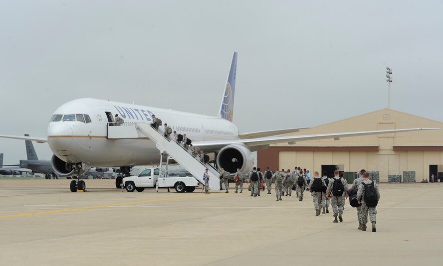 Airmen from the 2nd Bomb Wing board a flight to Guam for a deployment from Barksdale Air Force Base, La., Sept. 3, 2014. B-52H Stratofortress' and aircrew from the 96th Bomb Squadron and 2nd BW Airmen, are deploying in support of the continuous bomber presence in the Pacific, a standing Air Force Global Strike Command deterrence mission. (U.S. Air Force photo/Senior Airman Joseph A. Pagán Jr.) 