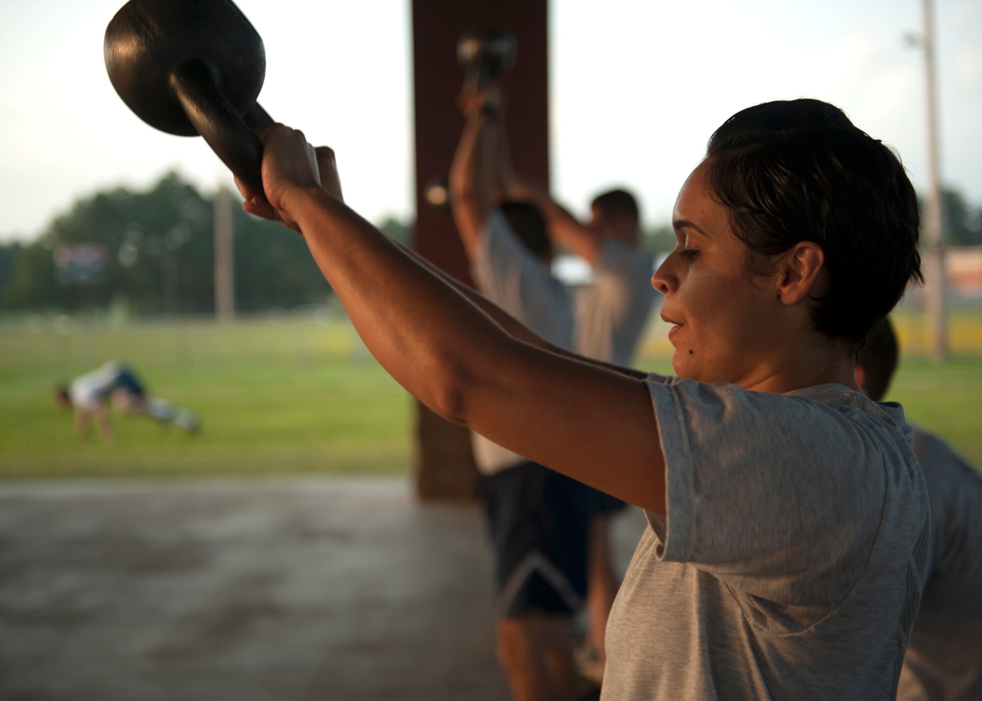 Staff Sgt. Melissa Colon, a 19th Communications Squadron unit deployment manager, lifts a kettle bell during squadron physical training Aug. 27, 2014, at Little Rock Air Force Base, Ark. The physical domain of Comprehensive Airmen Fitness encourages Airmen to strengthen their resilience through focusing on fitness, endurance, nutrition or even sleep habits. (U.S. Air Force photo by Airman 1st Class Scott Poe)