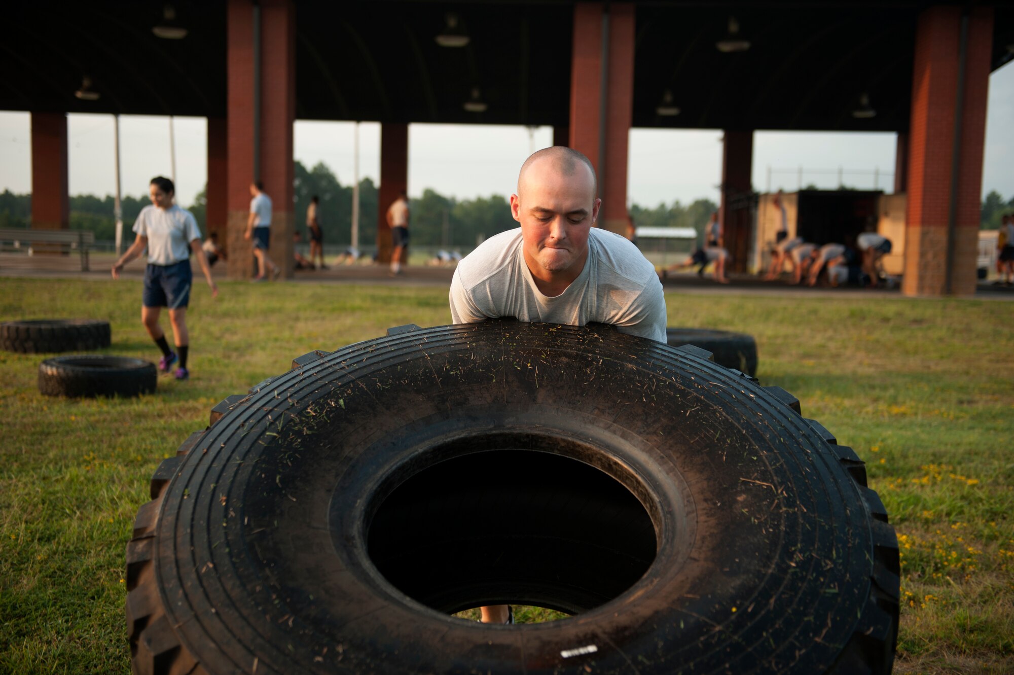 Staff Sgt. James Gentry, a 19th Communications Squadron cyber transport supervisor, lifts a tire during squadron physical training Aug. 27, 2014, at Little Rock Air Force Base, Ark. The 19th CS PT session consisted of multiple workouts including tire flips, bear crawls, kettle bells, burpies and more. (U.S. Air Force photo by Airman 1st Class Scott Poe)