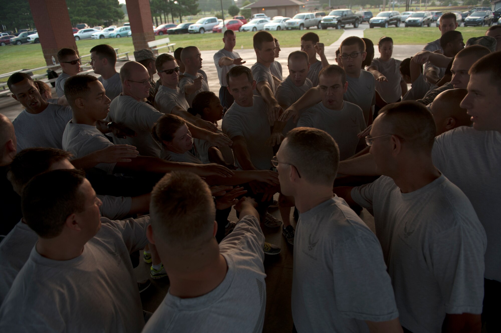 Members of the 19th Communications Squadron gather together for physical training Aug. 27, 2014, at Little Rock Air Force Base, Ark. Airmen are required to take a PT test at least once a year, so staying physically fit is crucial to maintaining readiness and Air Force standards. (U.S. Air Force photo by Airmen 1st Class Scott Poe) 