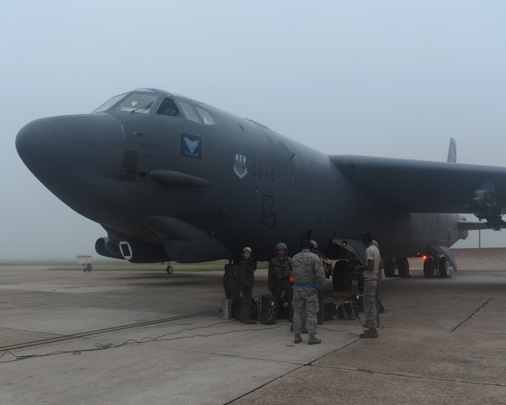 Aircrew members from the 96th Bomb Squadron prepare to enter a B-52H Stratofortress on Barksdale Air Force Base, La., Sept. 3, 2014. Airmen from the 96th BS and support staff from the 2nd Bomb Wing are deploying to Andersen Air Force Base, Guam, for a six-month rotation in support of the continuous bomber presence in the Pacific region. (U.S. Air Force photo/Senior Airman Benjamin Gonsier)