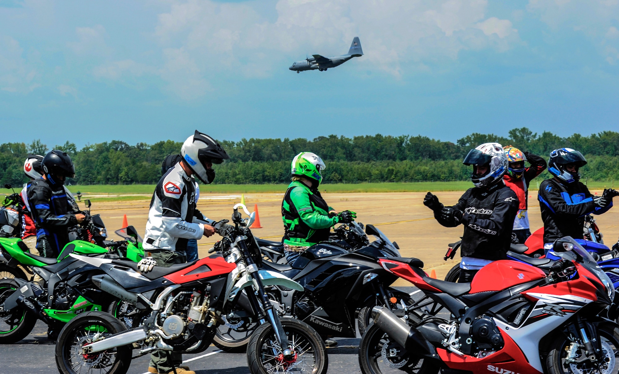 A C-130H approaches to land as Airmen and civilians prepare for a motorcycle safety course Aug. 25, 2014, at Little Rock Air Force Base, Ark. The 8-hour long course taught riders street performance maneuvers. (U.S. Air Force photo by Airman 1st Class Harry Brexel)  