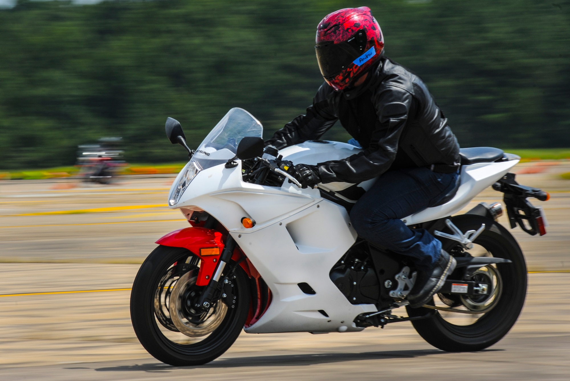 An Airman veers to the left on his motorcycle as part of a rider safety course Aug. 25, 2014, at Little Rock Air Force Base, Ark. The Motorcycle Safety Foundation accredited class taught valuable maneuvering techniques including cornering, body positioning and performance breaking. (U.S. Air Force photo by Airman 1st Class Harry Brexel)  