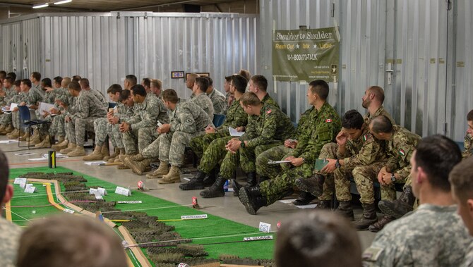 U.S. Army, Royal Canadian Regiment and Italian Esercito soldiers are briefed on the upcoming operations as part of Steadfast Javelin II on Rhein Ordnance Barracks, Germany, Sept. 3, 2014. The exercise features a number of dynamic events designed to challenge the multi-national forces in airborne operations, conventional warfare scenarios as well as stability and defensive operations, and support of civil authorities operations. (U.S. Air Force photo/Airman 1st Class Jordan Castelan)