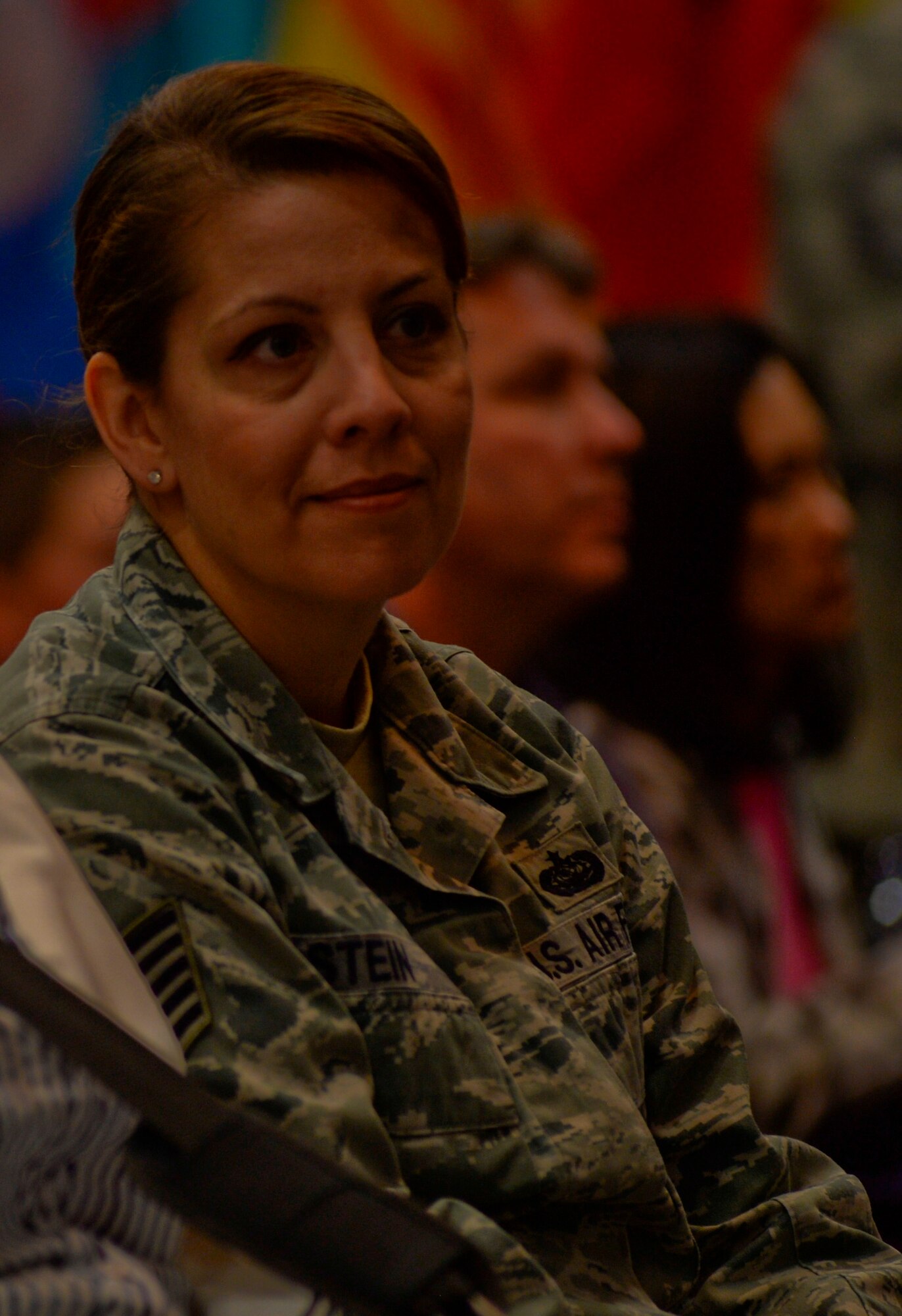 U.S. Air Force Tech. Sgt. Erika Stein, assistant to the 52nd Fighter Wing command chief, listens to a presentation as part of the Diversity Day celebration at Club Eifel at Spangdahlem Air Base, Germany, Aug. 25, 2014. The presentation highlighted the care provided to displaced children who survived the Holocaust, including Stein’s grandfather, Morris. (U.S. Air Force photo by Staff Sgt. Joe W. McFadden/Released)