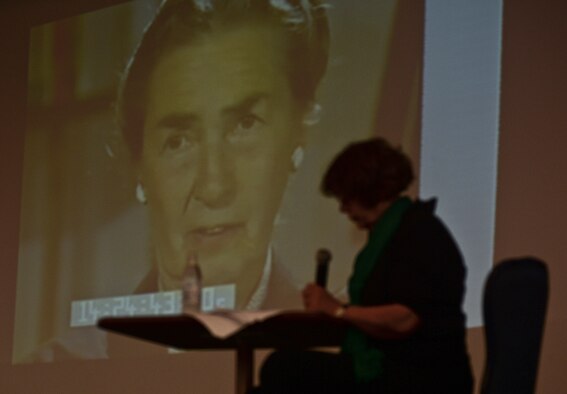 Anna Andlauer, an educator from Markt Indersdorf, Germany, foreground, looks at her notes as a video of Greta Fischer, a German social worker, plays on a screen as part of the Diversity Day celebration at Club Eifel at Spangdahlem Air Base, Germany, Aug. 25, 2014. Andlauer spoke during the event about Fischer’s work to help displaced children after the Holocaust. (U.S. Air Force photo by Staff Sgt. Joe W. McFadden/Released)