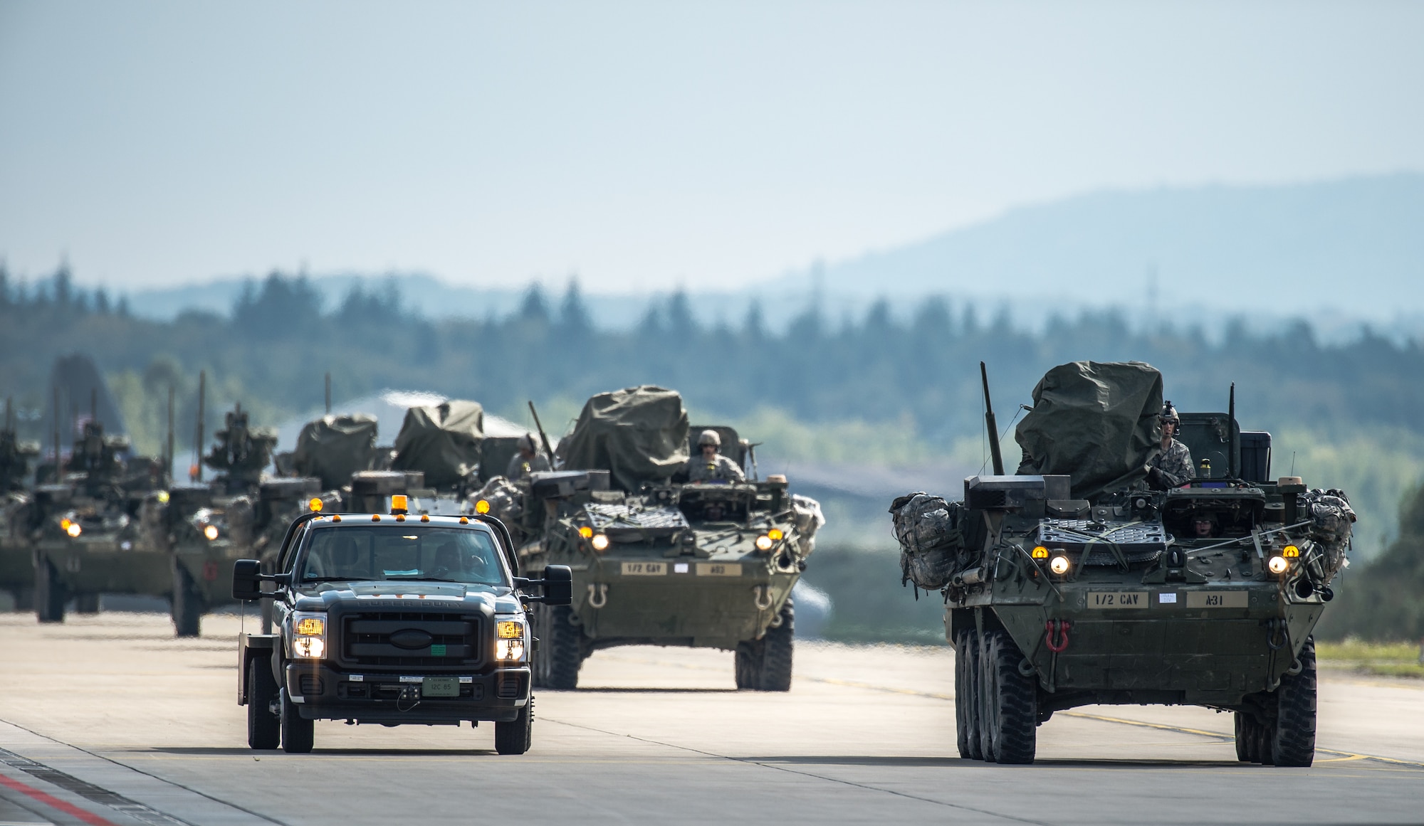 U.S. Army Stryker infantry carrier vehicles convoy across the flightline during operations in support of Steadfast Javelin II on Ramstein Air Base, Germany, Sept. 3, 2014. The exercise features a number of dynamic events designed to challenge the multi-national forces in airborne operations, conventional warfare scenarios as well as stability and defensive operations, and support of civil authorities operations. (U.S. Air Force photo/Airman 1st Class Jordan Castelan)