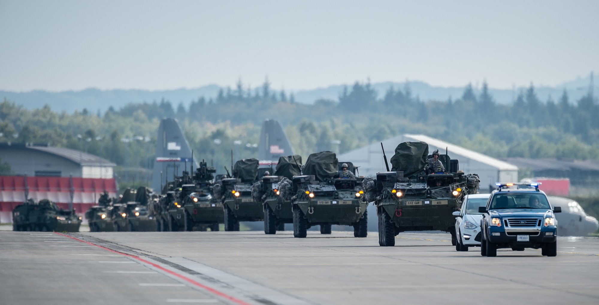 U.S. Army Stryker infantry carrier vehicles convoy across the flightline during operations in support of Steadfast Javelin II on Ramstein Air Base, Germany, Sept. 3, 2014. The exercise features a number of dynamic events designed to challenge the multi-national forces in airborne operations, conventional warfare scenarios as well as stability and defensive operations, and support of civil authorities operations. (U.S. Air Force photo/Airman 1st Class Jordan Castelan)