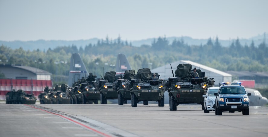 U.S. Army Stryker infantry carrier vehicles convoy across the flightline during operations in support of Steadfast Javelin II on Ramstein Air Base, Germany, Sept. 3, 2014. The exercise features a number of dynamic events designed to challenge the multi-national forces in airborne operations, conventional warfare scenarios as well as stability and defensive operations, and support of civil authorities operations. (U.S. Air Force photo/Airman 1st Class Jordan Castelan)