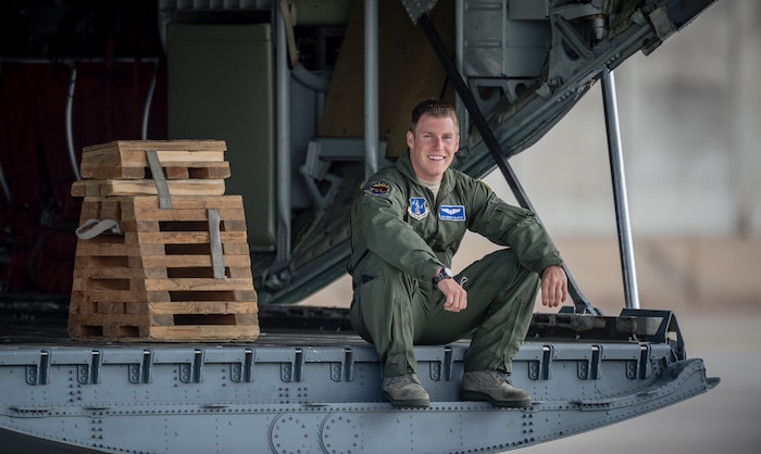 U.S. Air Force National Guard Senior Airman Garrett Gillette, 115th Airlift Squadron loadmaster sits on the ramp of a C-130J Super Hercules while watching U.S. Army Stryker infantry carrier vehicles drive past on Ramstein Air Base's flightline as part of Steadfast Javelin II, Sept. 3, 2014, Germany. The U.S. Air Force and Air National Guard support this exercise by providing personnel air drop and air landings in support of forcible entry and force projection,  reinforcing the joint commitment to Operation Atlantic Resolve, and a  demonstrated commitment to our NATO allies and security in Eastern Europe.(U.S. Air Force photo/Airman 1st Class Jordan Castelan)