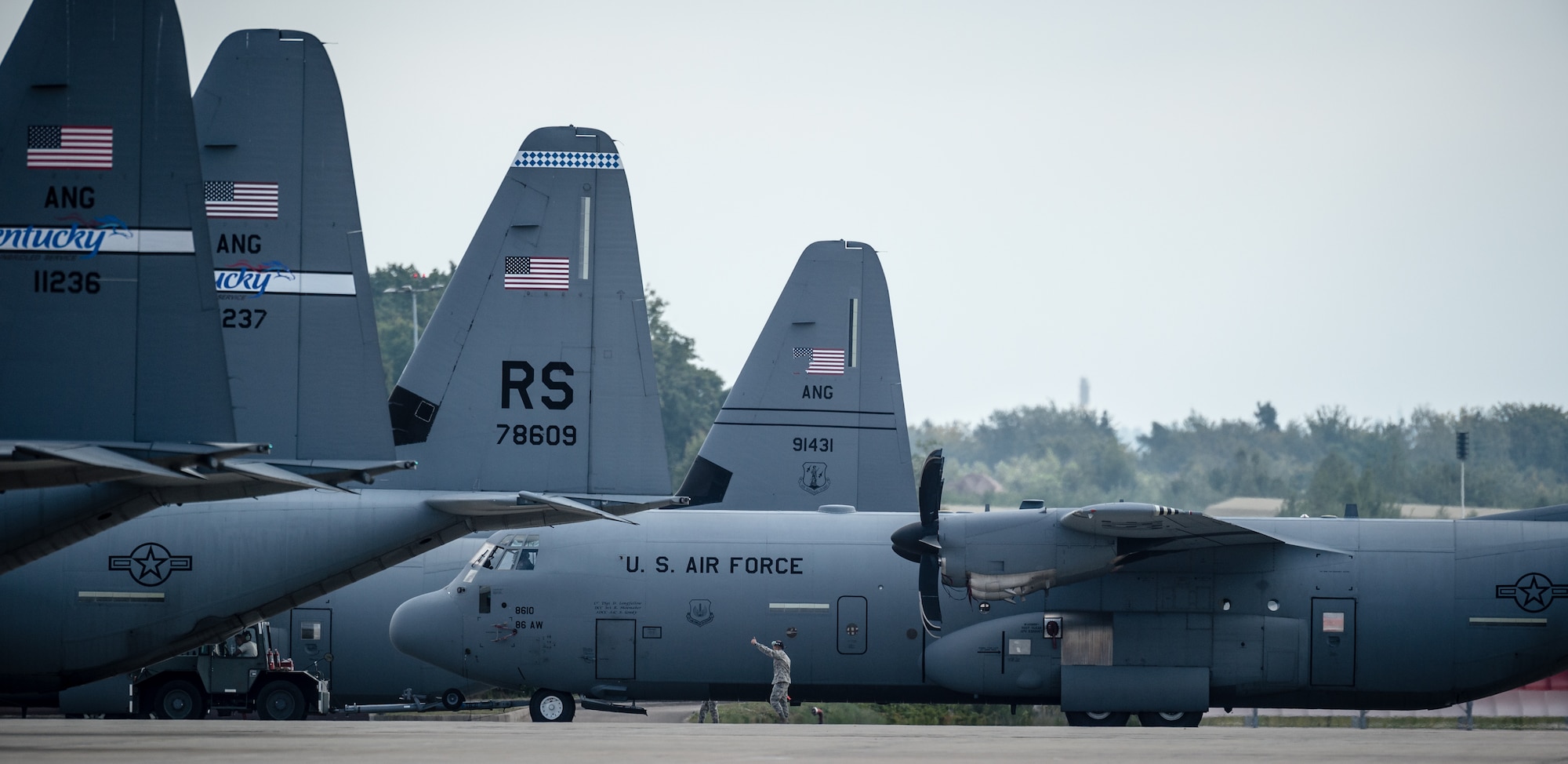 Airmen from the 86th Aircraft Maintenance Squadron tow a 37th Airlift Squadron C-130J Super Hercules into position for Steadfast Javelin II on Ramstein Air Base, Germany, Sept. 3, 2014. This exercise prepares U.S., NATO Allies and European security partners to conduct unified land operations through the simultaneous combination of offensive, defensive, and stability operations appropriate to the mission and the environment, and to sustain interoperability with partner nations. (U.S. Air Force photo/Airman 1st Class Jordan Castelan)