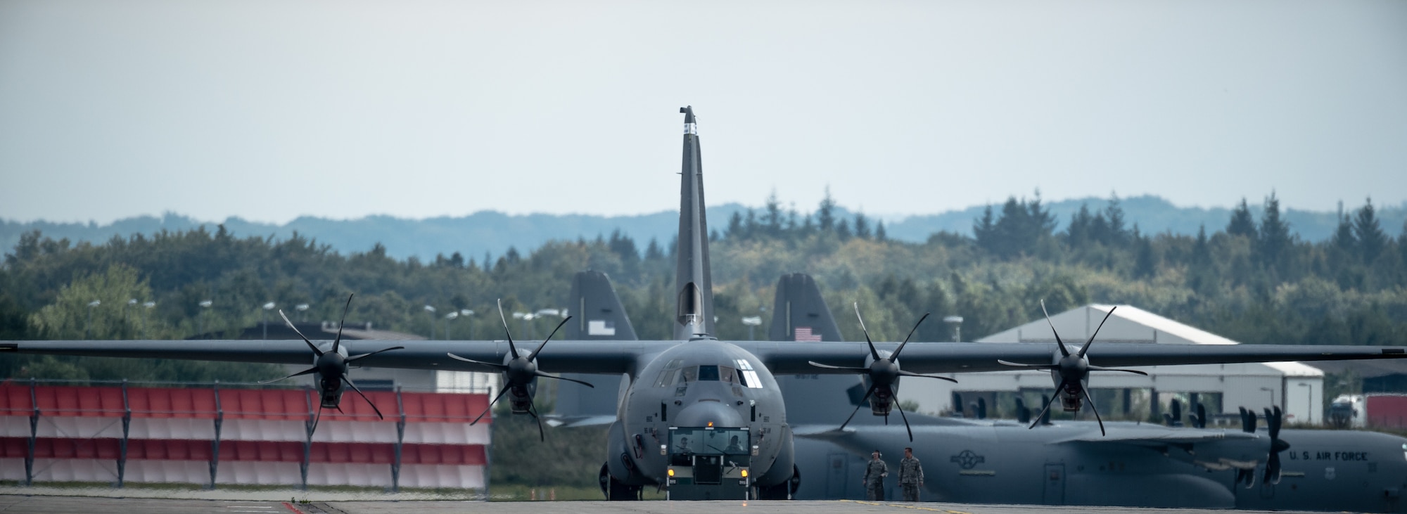 Airmen from the 86th Aircraft Maintenance Squadron tow a 37th Airlift Squadron C-130J Super Hercules into position for Steadfast Javelin II on Ramstein Air Base, Germany, Sept. 3, 2014. This exercise prepares U.S., NATO Allies and European security partners to conduct unified land operations through the simultaneous combination of offensive, defensive, and stability operations appropriate to the mission and the environment, and to sustain interoperability with partner nations. (U.S. Air Force photo/Airman 1st Class Jordan Castelan)