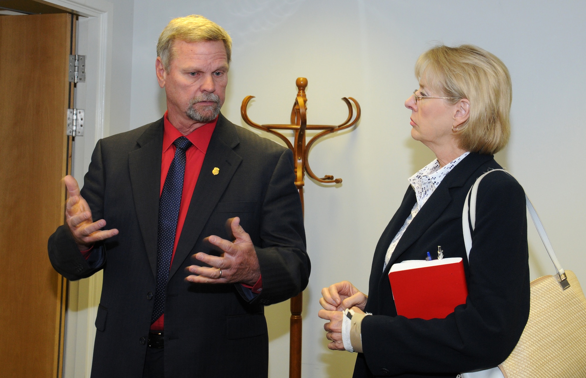 Special Agent Timothy Olive, left, Air Force Office of Special Investigation Detachment 512 commander, gives a mission brief to Jeanette James, subcommittee on military personnel majority lead, Aug. 19, 2014, on RAF Mildenhall, England. Olive explained what his office offers for victims and showed them the new specialized interview suite. (U.S. Air Force photo/Gina Randall/Released)