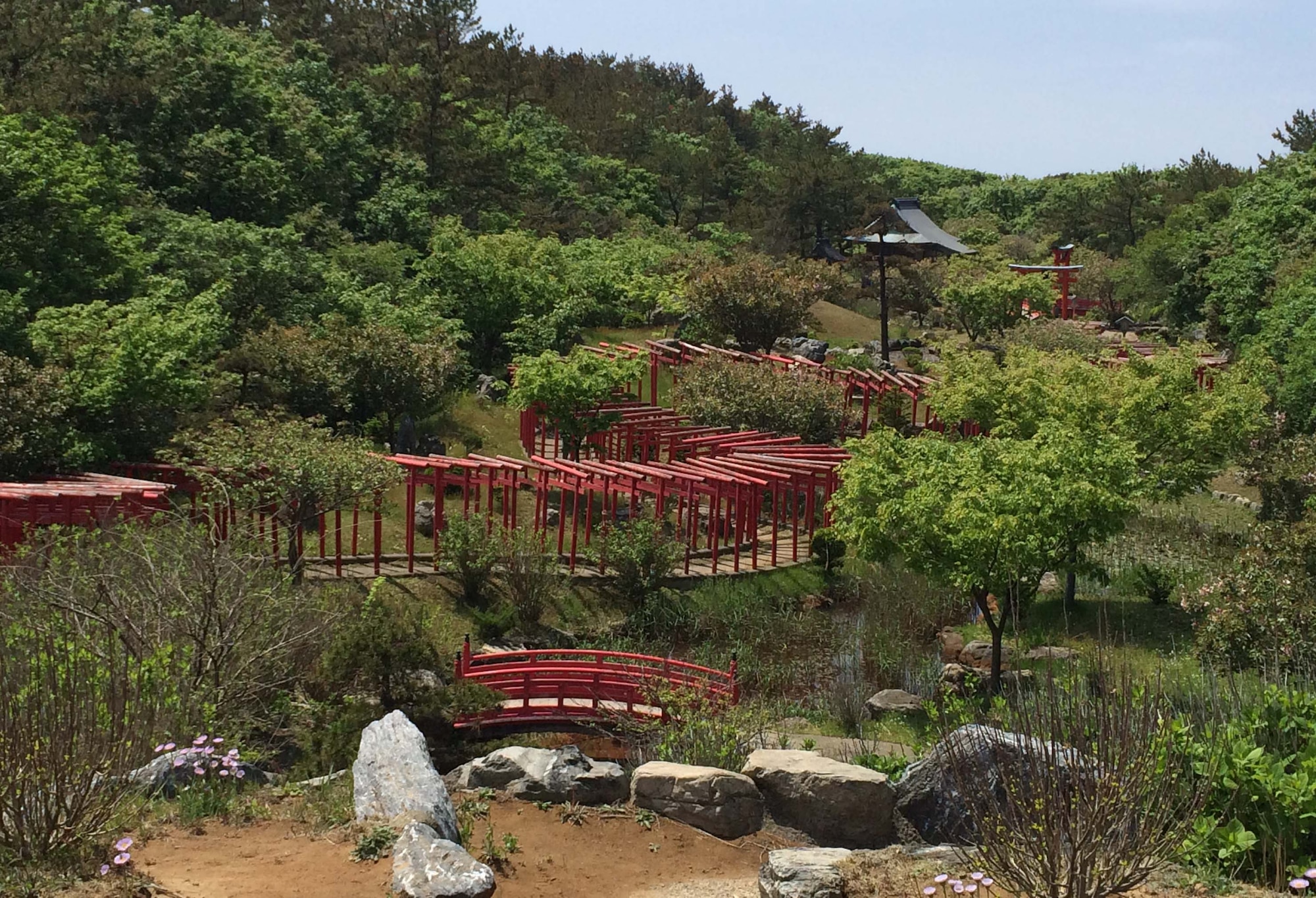 A winding trail of torii gates lies between the Tatayama Inari shrine and the western coast line at Goshogawara, Japan, Aug. 31, 2014. There are more than 200 of these gates in a row and they stand approximately six feet tall. Crossing through a torii gate is said to symbolize the entrance into sacred space. (U.S. Air Force photo by Airman 1st Class Patrick S. Ciccarone/Released)
