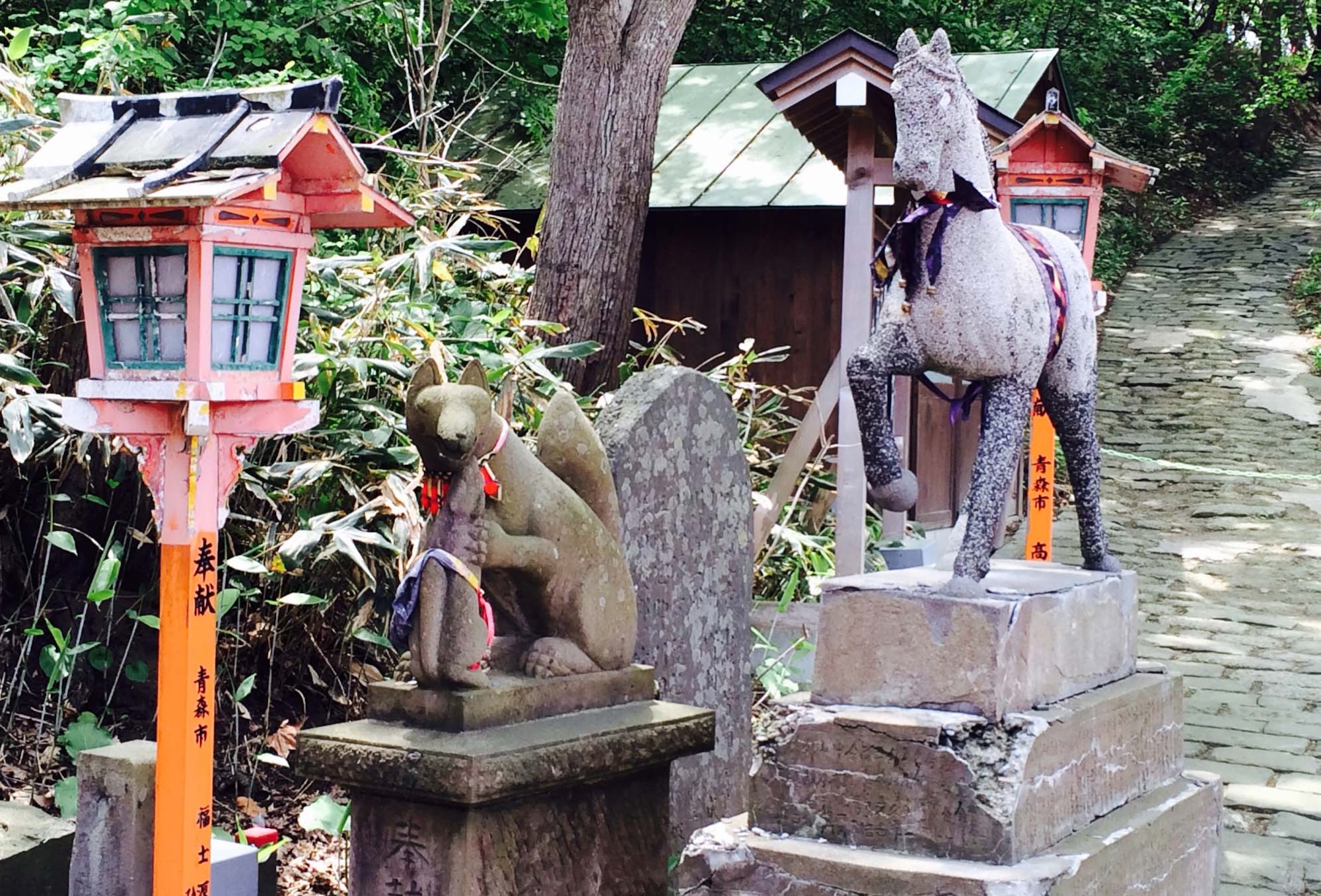 Statues of animal spirits welcome visitors at the entrance of the Tatayama Inari shrine in Goshogawara, Japan, Aug. 31, 2014. The prominent kami (deity) for this shrine is the O-Inari, or fox who gives good fortune for fertility, agriculture and saké and is frequently placed among Shinto shrines. (U.S. Air Force photo by Airman 1st Class Patrick S. Ciccarone/Released)
