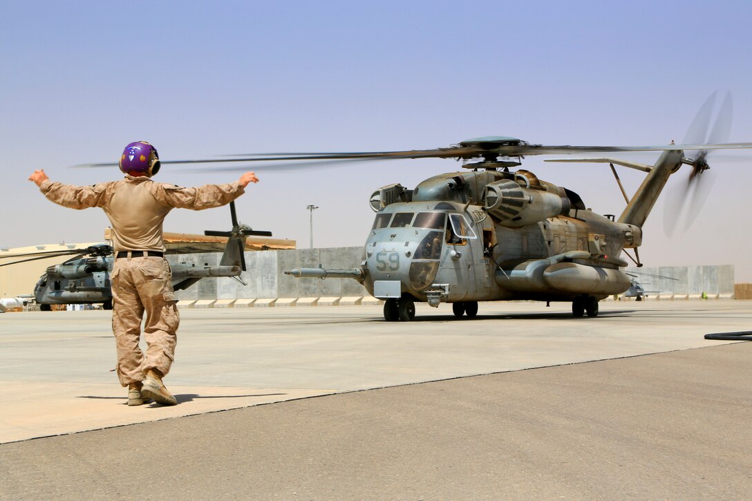 U.S. Marine Sgt. Joshua Morrison gives pilots the all clear after refueling a Super Stallion helicopter at a forward arming and refueling point on Camp Bastion in Afghanistan's Helmand province, Sept. 3, 2014. Morrison is a fuel chief assigned to Marine Wing Support Squadron 274.
