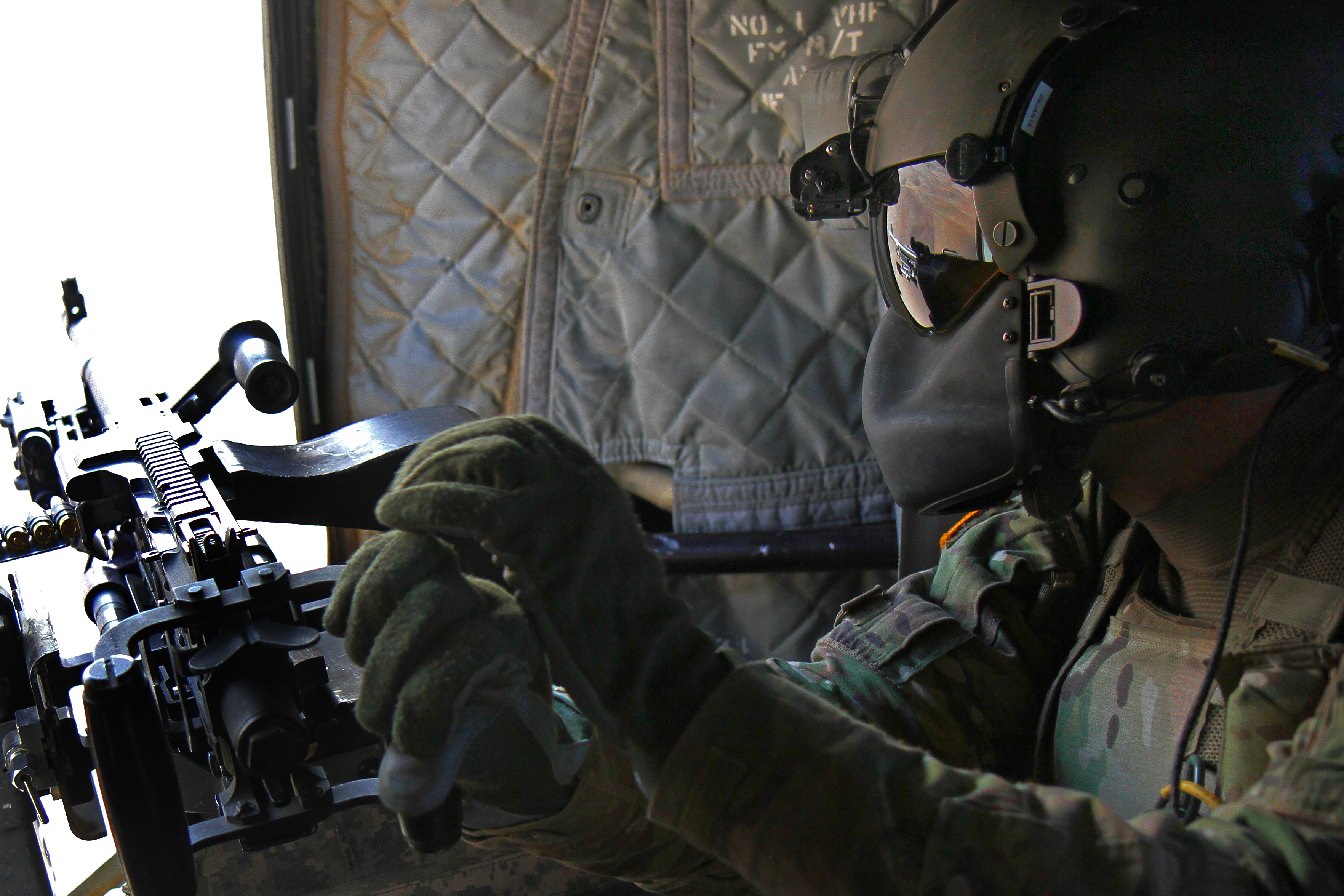 An Army door gunner prepares to conduct a test fire with a M240 machine