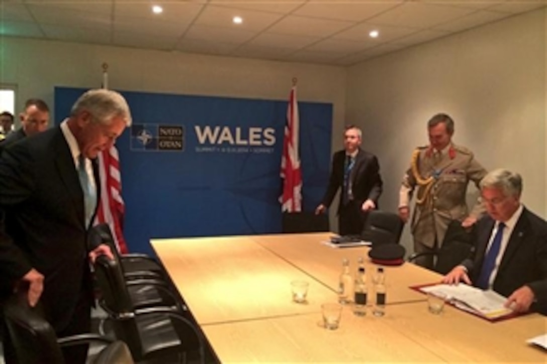 U.S. Defense Secretary Chuck Hagel (left) sits down for a meeting with British Defense Secretary Michael Fallon (right) during a NATO summit in Wales, Sept. 4, 2014.