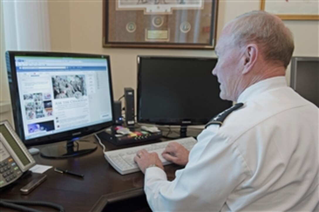 Army Gen. Martin E. Dempsey, chairman of the Joint Chiefs of Staff, communicates with service members as he hosts a Facebook town hall meeting from his office at the Pentagon, Sept. 4, 2014.