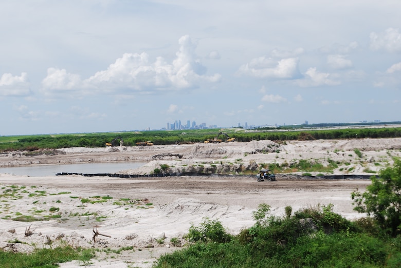 With Tampa in the distance, dike construction continues at 3-D to increase its capacity to 15-million cubic yards for use in disposing Tampa Harbor Project dredged materials.