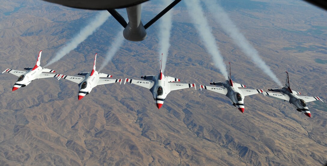 F-16 Fighting Falcons Thunderbirds perform a five-ship formation after refueling from a 92nd Air Refueling Wing KC-135 Stratotanker Sept. 1, 2014, over Glacier National Park, Mont. The Thunderbirds were making their way back to Nellis Air Force Base, Nev., where they are assigned to the 57th Wing’s U.S. Air Force Air Demonstration Squadron. (U.S. Air Force photo/Airman 1st Class Janelle Patiño)