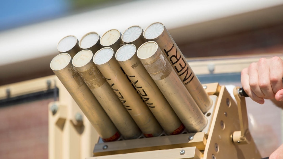 Marines with II Marine Expeditionary Force practice loading and unloading inert rounds into the Non-Lethal, Tube-Launched Munitions System during their practical application training at Camp Lejeune, North Carolina, Aug. 14, 2014. Marine Corps Systems Command Optics and Non-Lethal Systems is fielding the system that sends non-lethal munitions out as far as 500 meters and uses an audible bang to deter a crowd or a person with mal-intent. Its intended use is for military checkpoints. 