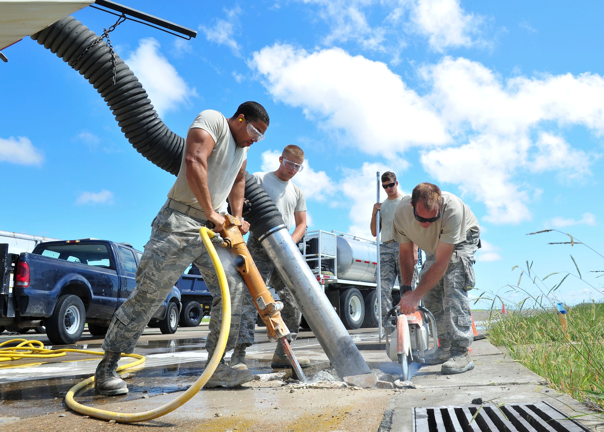 Airmen from the 633rd Civil Engineer Squadron repair sections of the runway Aug. 27, 2014, at Langley Air Force Base, Va. The improvements will provide a safe environment to sustain current flying operations and secure future mission capability. (U.S. Air Force photo/Senior Airman Connor Estes)