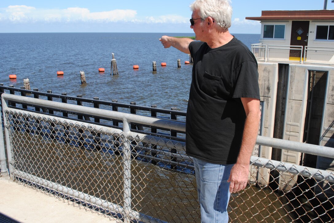 Port Mayaca Lock Operator Jon Fields points to the area where he discovered an injured manatee on March 15.  Fields made initial notification to authorities who later rescued the manatee and nursed it to health.  