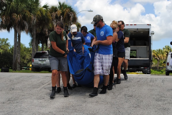 Staff with the Florida Fish & Wildlife Conservation Commission (FWC) release the rescued manatee back into the St. Lucie Canal on August 13 after it was nursed to health.  