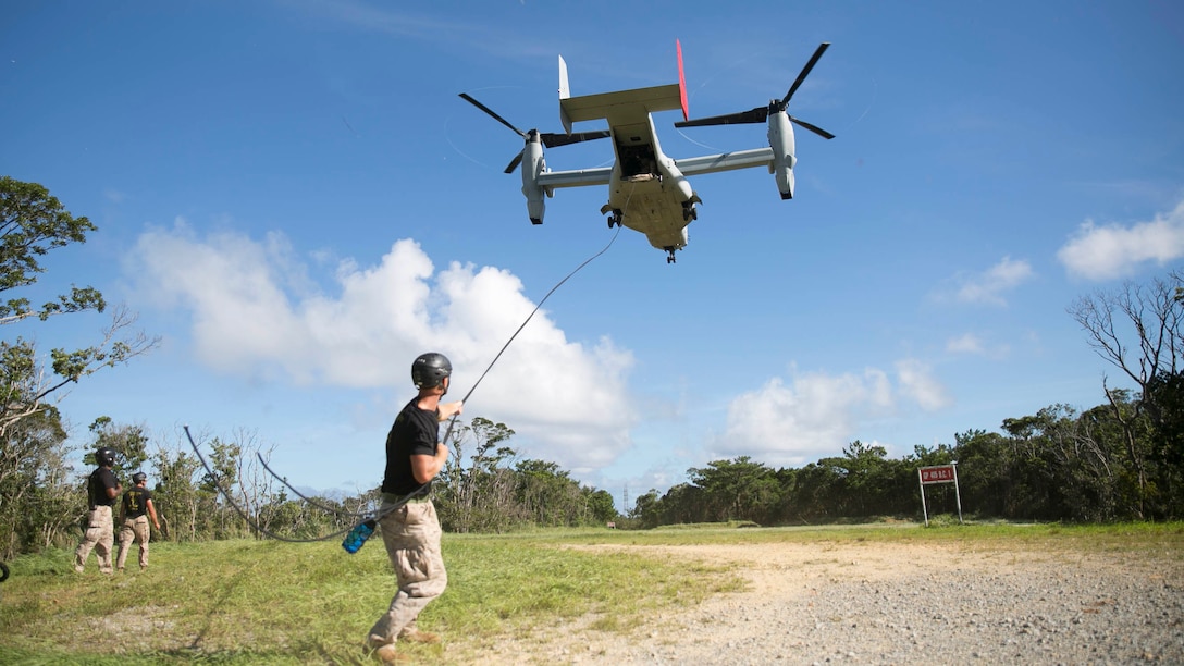 Sgt. Geoffrey P. Mann, an Orlando, Florida, native, prepares to bullae so students can safely rappel down from an MV-22B Osprey during the Helicopter Rope Suspension Techniques course Aug. 20 at the Central Training Area. Throughout the course the instructors ensure the safety procedures are followed, and the students are capable of safely sending other Marines down the rope. Mann is a HRST instructor with Special Operations Training Group, III Marine Expeditionary Force Headquarters Group, III MEF. The Osprey is with Marine Medium Tiltrotor Squadron 265, Marine Aircraft Group 36, 1st Marine Aircraft Wing, III MEF.