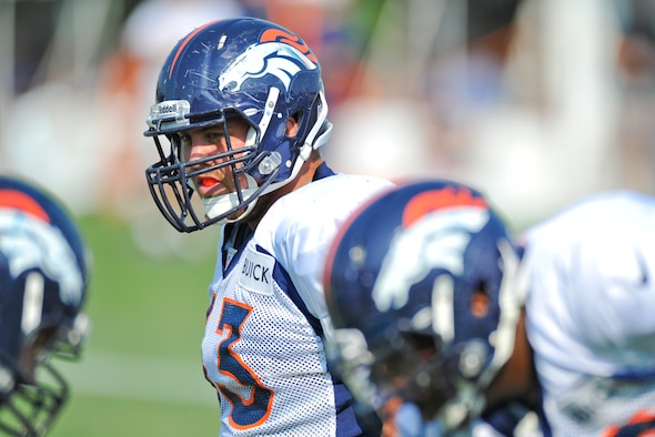 Ben Garland, Denver Broncos offensive guard, gets ready for the next drill during a training camp session Aug. 14, 2012, at the Broncos training facility in Englewood, Colo. Garland spent the 2012 season on the Broncos practice squad and transitioned from defensive tackle to offensive guard before the Broncos 2013 mini-camp. Garland is also a public affairs officer with the 140th Wing, Colorado Air National Guard, and served his annual commitment during the early part of 2013. (U.S. Air Force photo/Staff Sgt. Christopher Gross)