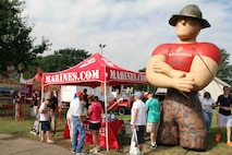 Minnesotans stop at the Marine Corps booth at the Minnesota State Fair to learn about the Marine Corps and conduct pull ups, August 22. Thoughout the course of the 12-day fair, thousands of fair-goers came to the Marine Corps booth to participate. 