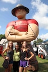 Minnisotans pose for a picture at the Marine Corps booth at the Minnesota State Fair, August 22. During the fair, many Minnesotans came to the Marine Corps booth to conduct pull ups, lift ammo-cans and learn about the Marine Corps. 