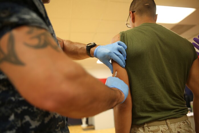 Petty Officer Third Class Steven J. Sechen, corpsman, Marine Corps Recruit Depot San Diego Branch Health Clinic, gives a vaccination to a recruit of Delta Company, 1st Recruit Training Battalion, at MCRD San Diego, Aug. 28. Immunizations that recruits receive take up to two weeks to take the full effect but in most cases, recruits are immune to each illness for the rest of their lives. Illnesses such as yellow fever require another vaccination in approximately 10 years.