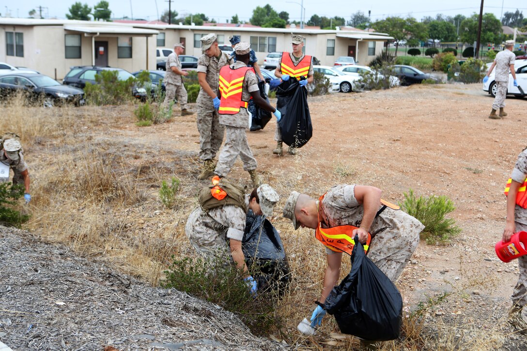 Marines with Marine Corps Air Station Miramar and 3rd Marine Aircraft Wing pick up trash during a station wide cleanup aboard MCAS Miramar, Calif., Sept. 4. The event was held to promote environmental stewardship aboard the installation.