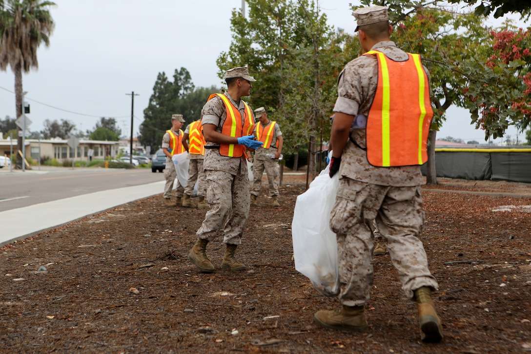 Marines with Marine Corps Air Station Miramar and 3rd Marine Aircraft Wing pick up trash during a station wide cleanup aboard MCAS Miramar, Calif., Sept. 4. Approximately 250 Service members participated in the event to promote environmental stewardship.