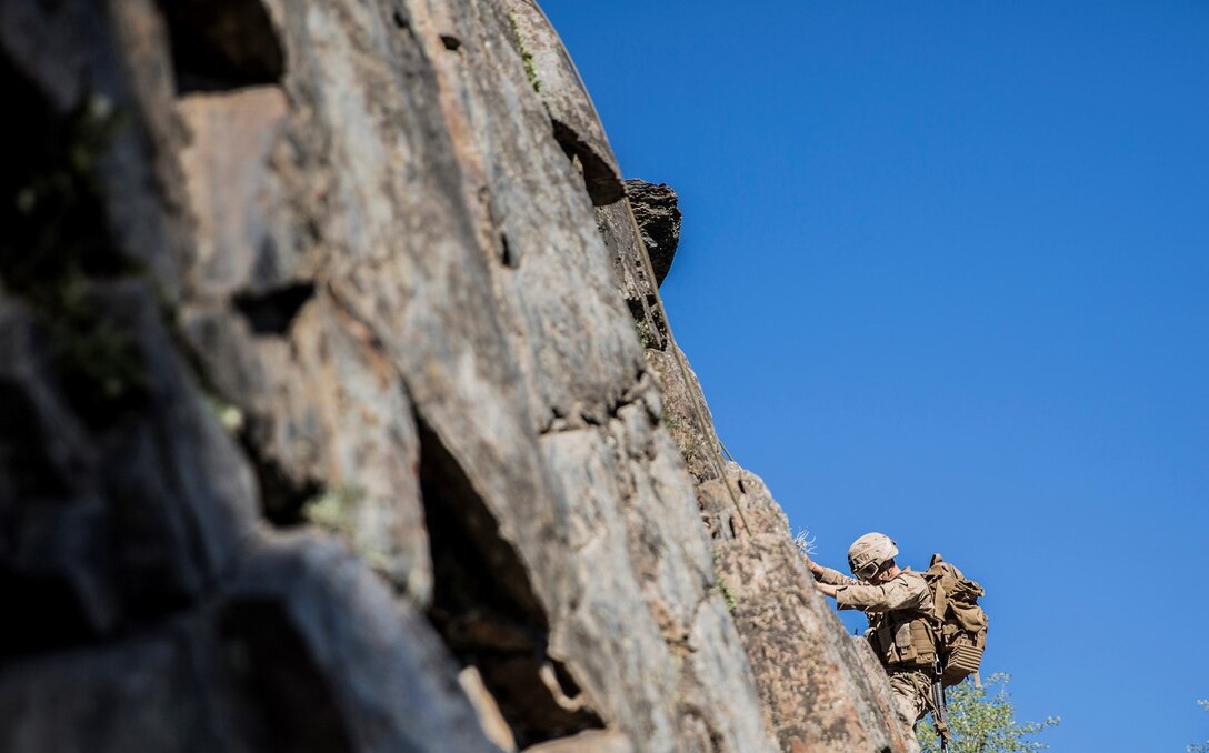 U.S. Marine Lance Cpl. Daniel Rice, 20, from Lake Tahoe, Calif.,  navigates his way up a cliff during Mountain Exercise 2014 aboard Marine Corps Mountain Warfare Training Center in Bridgeport, Calif., Sept. 1, 2014. Rice is an infantry rifleman with 1st Platoon, Lima Company, 3rd Battalion, 1st Marine Regiment. Marines with 3rd Battalion, 1st Marine Regiment will become the 15th Marine Expeditionary Unit’s ground combat element in October. Mountain Exercise 2014 develops critical skills the battalion will need during deployment. (U.S. Marine Corps photo by Sgt. Emmanuel Ramos/Released)