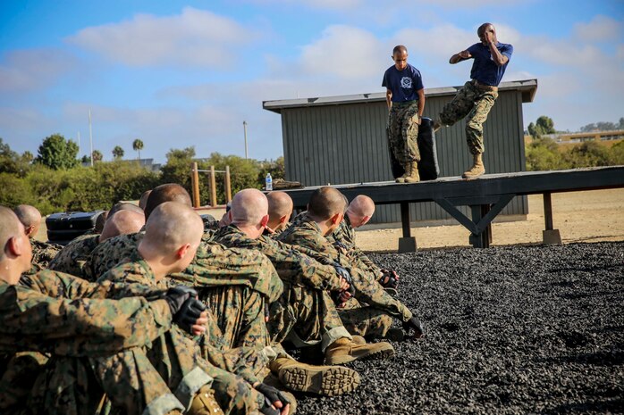 Drill instructors demonstrate the round kick to recruits of India Company, 3rd Recruit Training Battalion, at Marine Corps Recruit Depot San Diego, Calif., Aug. 29. Drill instructors gave a demonstration of each leg strike technique prior to allowing the recruits to practice the moves themselves.