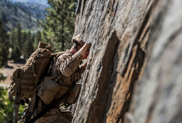 U.S. Marine Pvt. Tyler Knotts, 19, from Kingwood, W.V., grips a ledge as he navigates his way up a cliff during Mountain Exercise 2014 aboard Marine Corps Mountain Warfare Training Center in Bridgeport, Calif., Sept. 1, 2014. Rice is an infantry rifleman with 1st Platoon, Lima Company, 3rd Battalion, 1st Marine Regiment. Marines with 3rd Battalion, 1st Marine Regiment will become the 15th Marine Expeditionary Unit’s ground combat element in October. Mountain Exercise 2014 develops critical skills the battalion will need during deployment. (U.S. Marine Corps photo by Sgt. Emmanuel Ramos/Released)