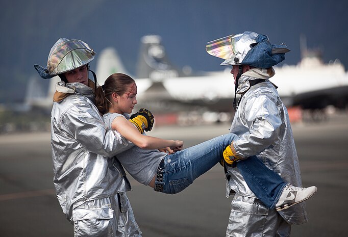 MARINE CORPS AIR STATION KANEOHE BAY - U.S. Marines with Aircraft Rescue Firefighting, Marine Corps Air Station Kaneohe Bay, carry a simulated casualty from an aircraft during Exercise Lethal Breeze on MCB Hawaii, Sept. 6, 2012. Base personnel and local emergency services worked together to perform crisis response following a simulated mass casualty incident and an aircraft mishap, testing their communication, command and control, and rescue and mass casualty measures. (U.S. Marine Corps photo by Sgt. Reece Lodder)
