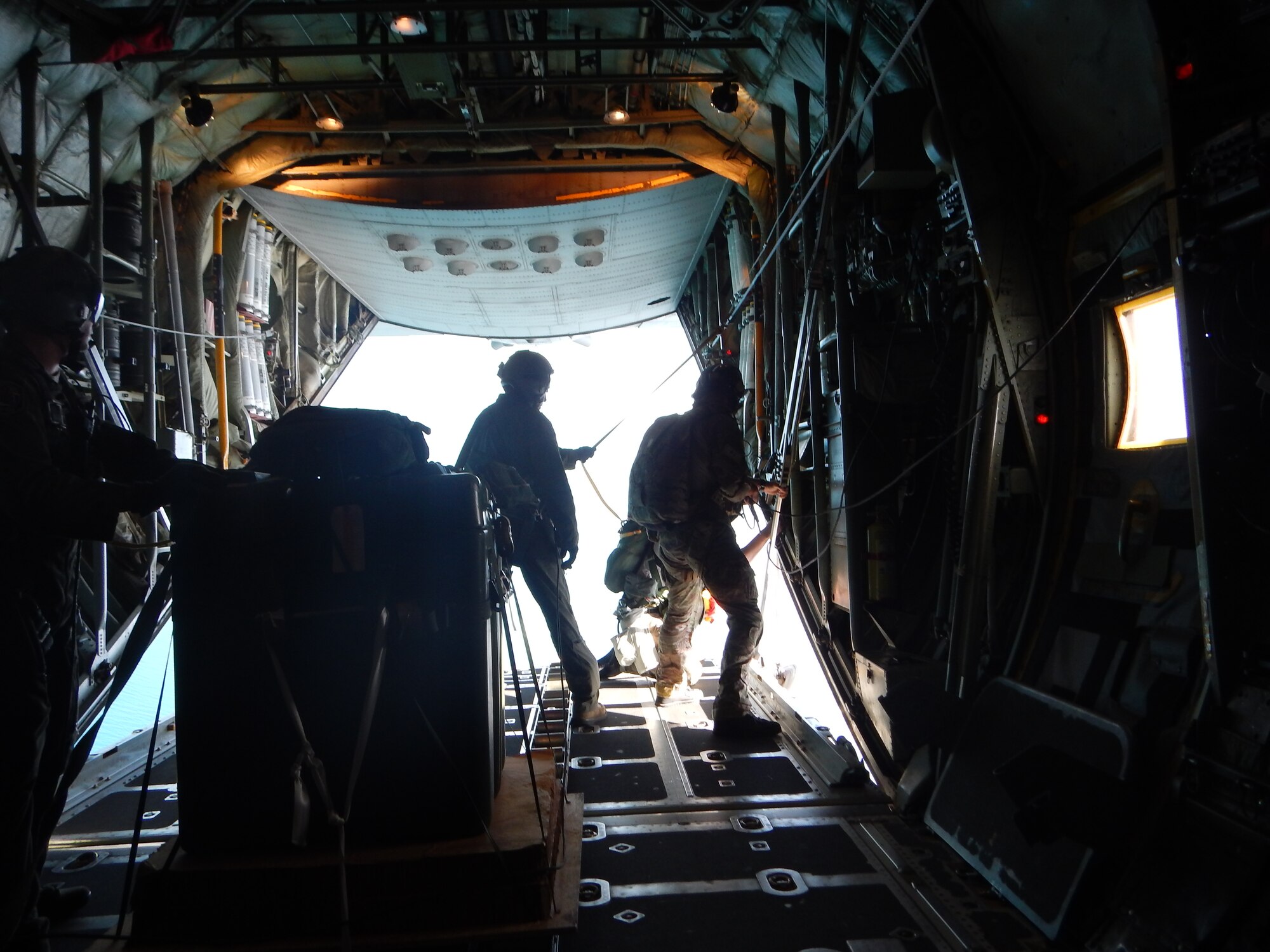 Pararescuemen observe a water target from the aircraft in preparation to release a re-supply bundle during a Rescue Jumpmaster course at Patrick Air Force Base, Fla, Aug. 12, 2014. The bundles are used during open ocean recovery operations. (U.S. Air Force courtesy photo)