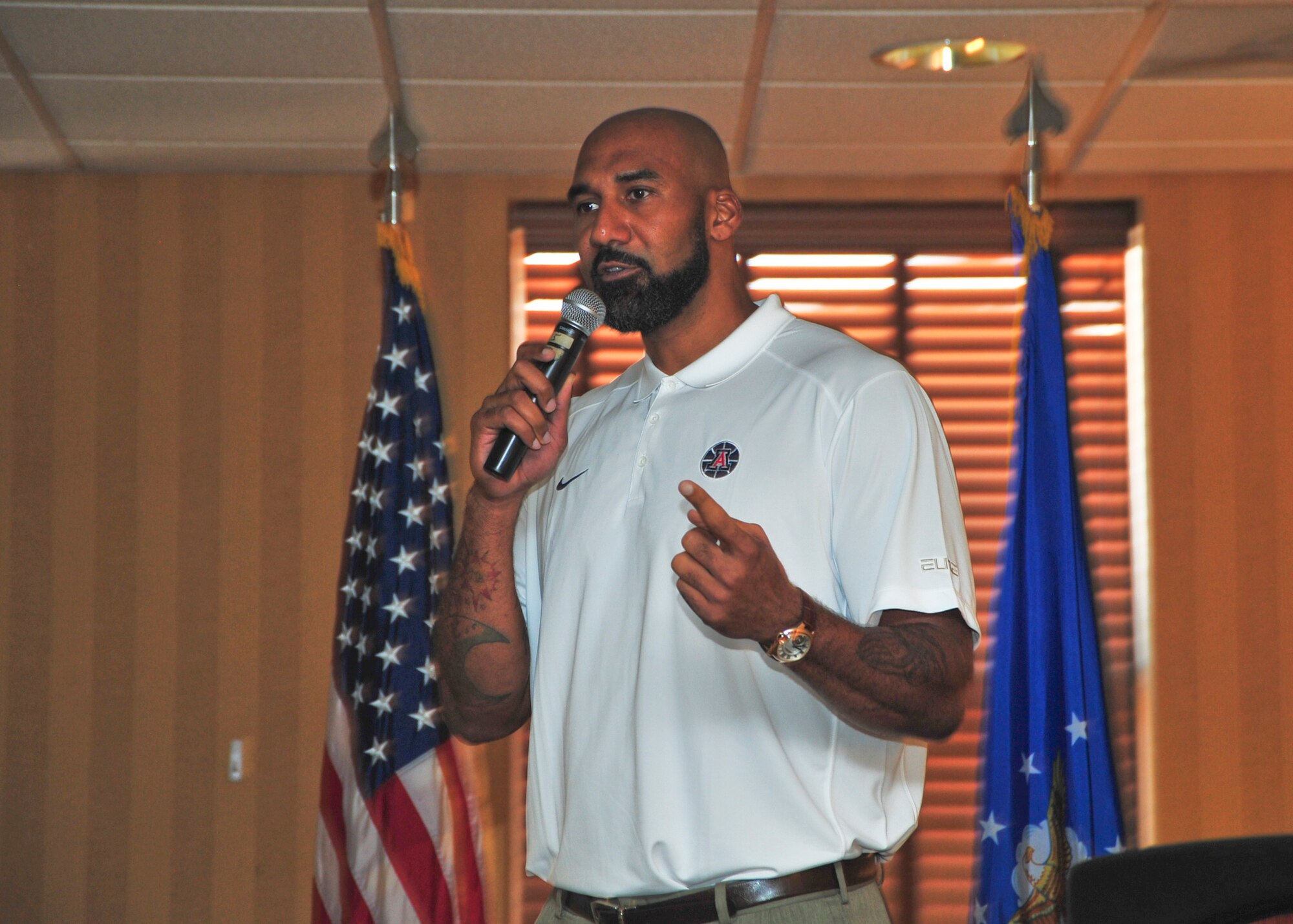 Joseph Blair, University of Arizona undergraduate assistant basketball coach, speaks at the 2014 Arizona Combined Federal Campaign Kick-off Breakfast at Davis-Monthan Air Force Base, Ariz., Sept. 4, 2014.  Blair volunteered to speak at the event to encourage teamwork and community support for the CFC.  (U.S. Air Force Photo by Airman 1st Class Chris Massey)